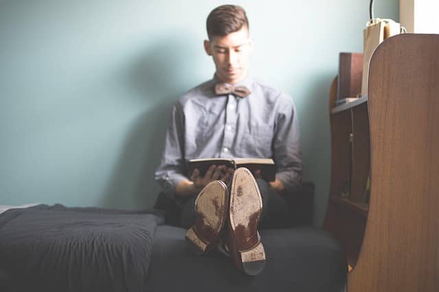 man reading in bed